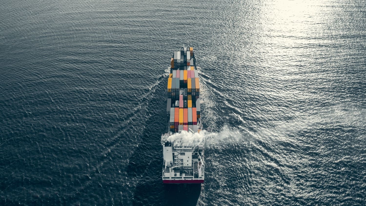 Large ship seen from behind on open ocean
